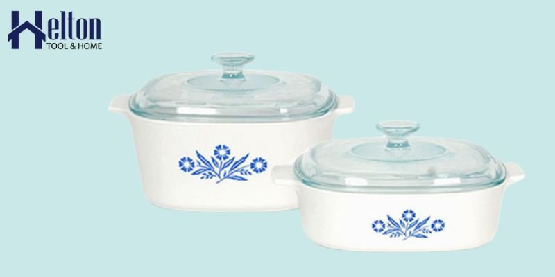 Various pieces of durable Corningware cookware arranged neatly on a modern kitchen counter.