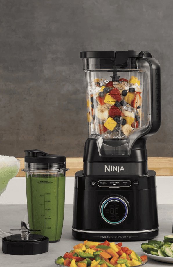 Various Ninja blender parts are organized neatly on a modern kitchen counter.