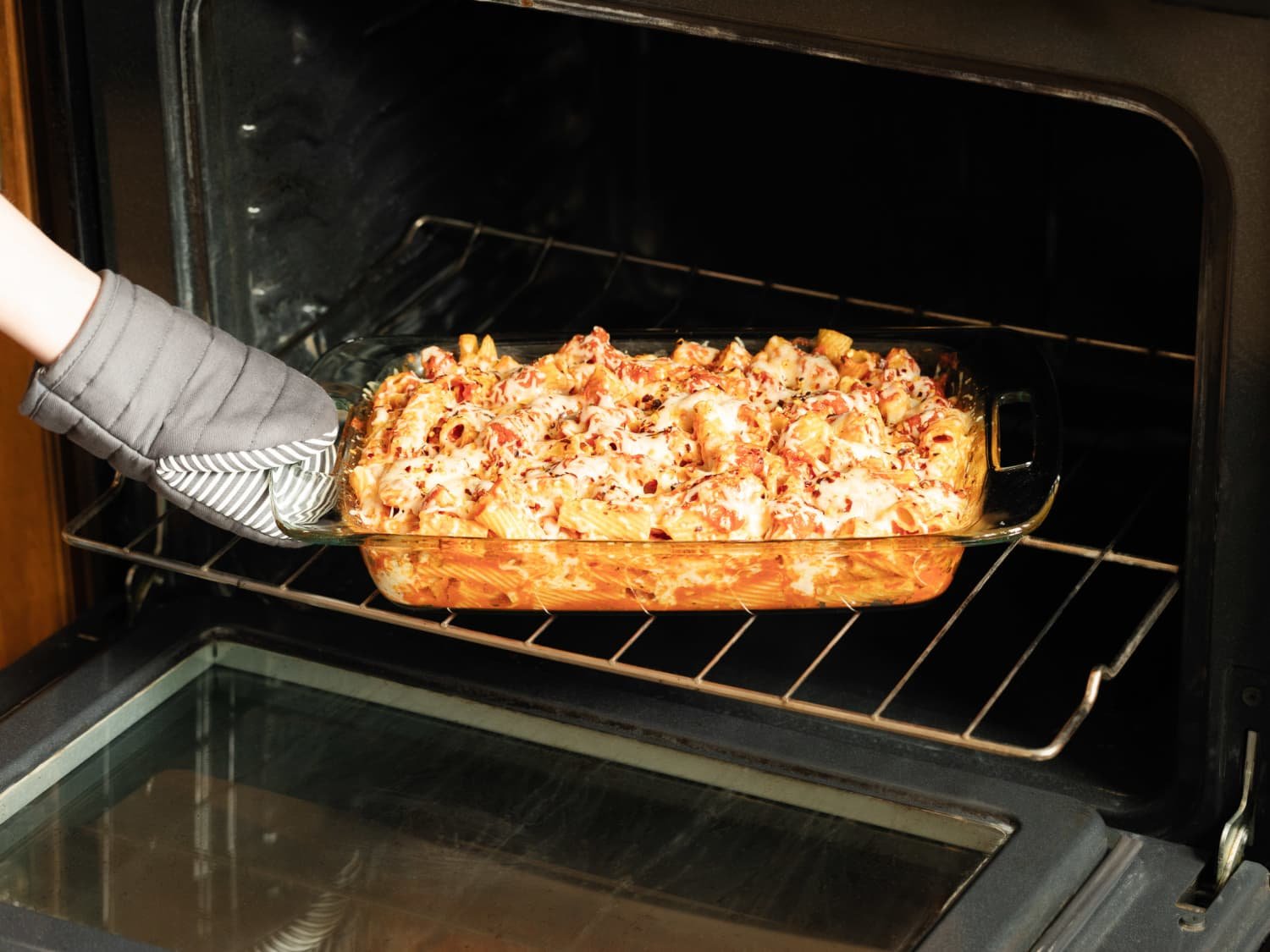 A clean Pyrex glass container with food sitting safely on a modern kitchen counter.