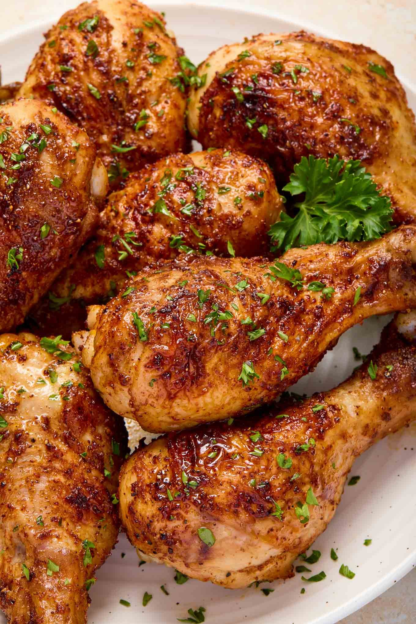 Perfectly crispy golden-brown chicken drumsticks resting on a white ceramic plate.
