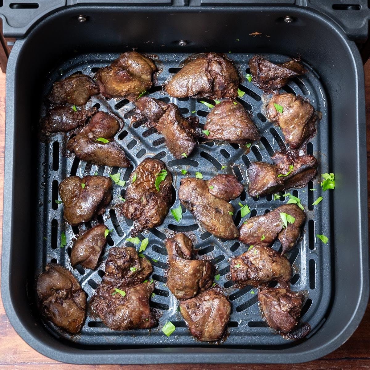 Preparation of chicken livers for the air fryer on a kitchen counter.