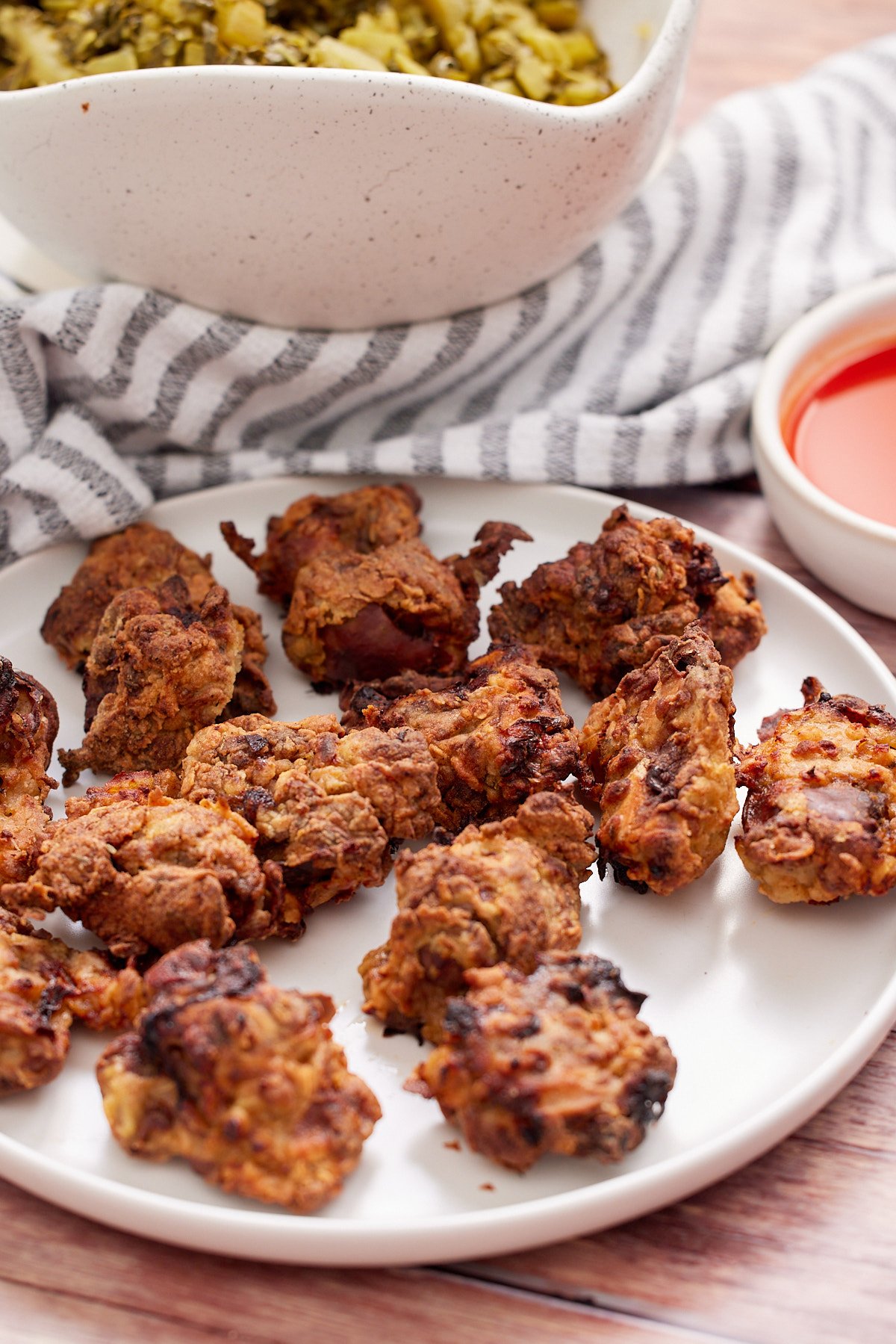 Using a knife to puncture chicken livers before cooking in an air fryer.