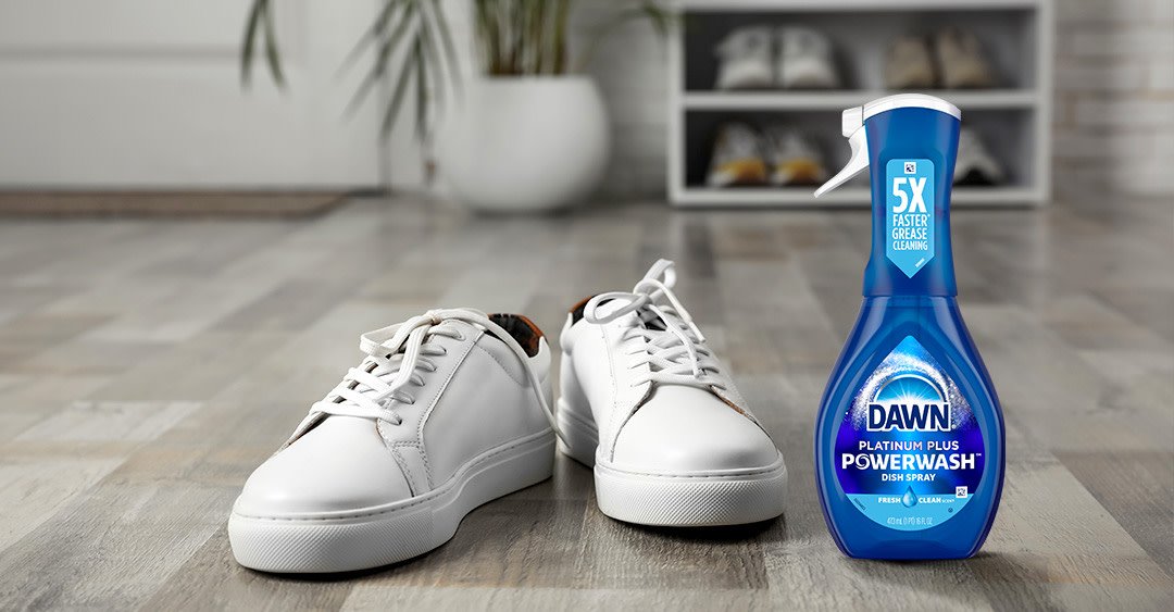 Cleaning materials arranged next to various types of shoes for proper care.