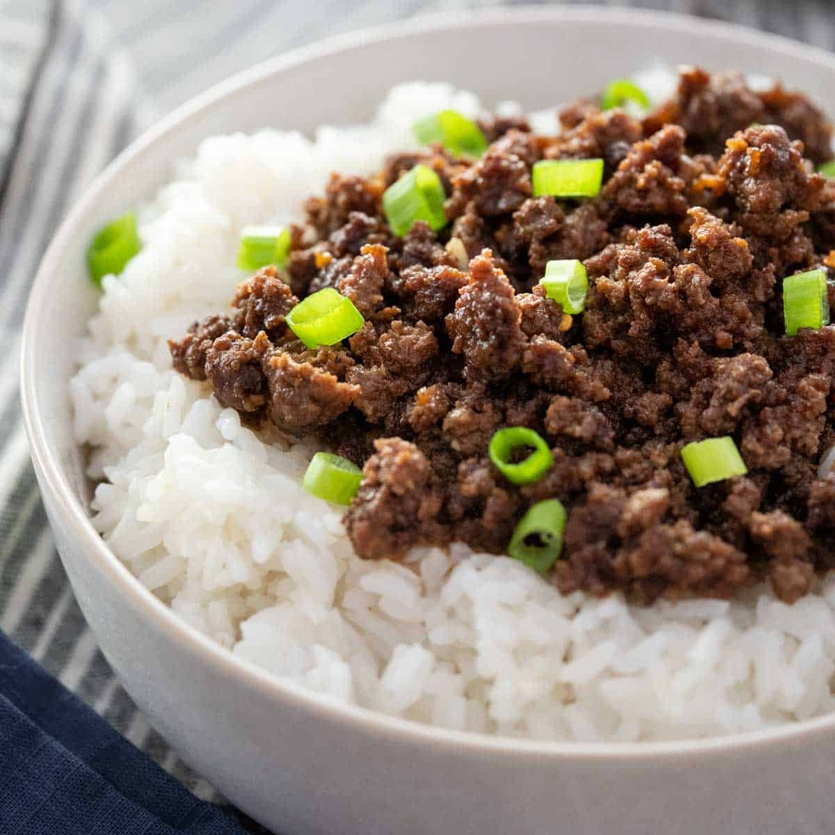 Inspecting raw ground beef for signs of spoilage before attempting to cook it.