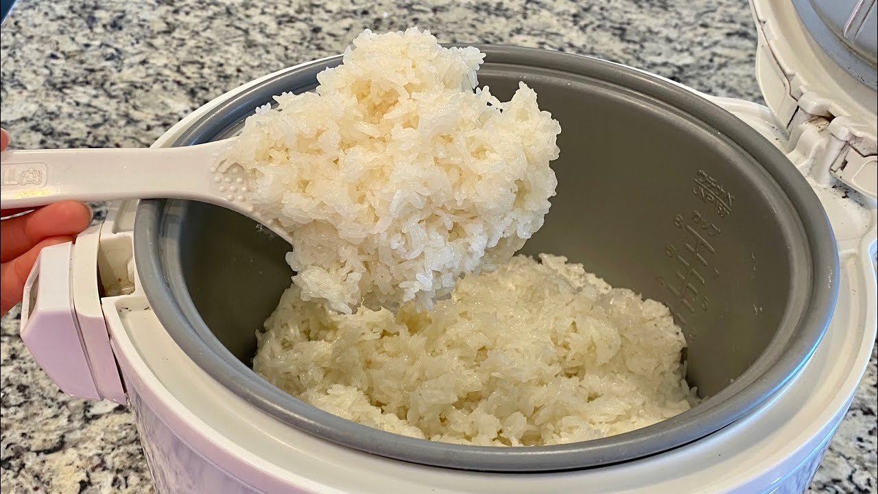 Overcooked and mushy sticky rice inside a rice cooker pot showing a cooking error.