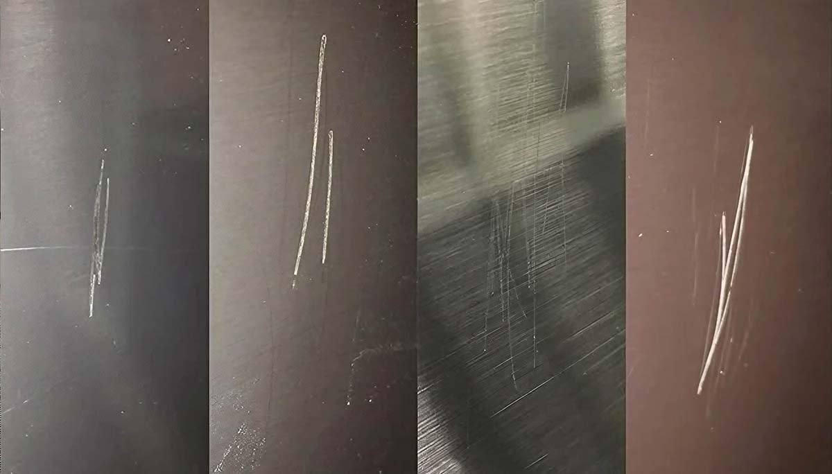Professional tools for repairing stainless steel scratches laid out on a workbench.