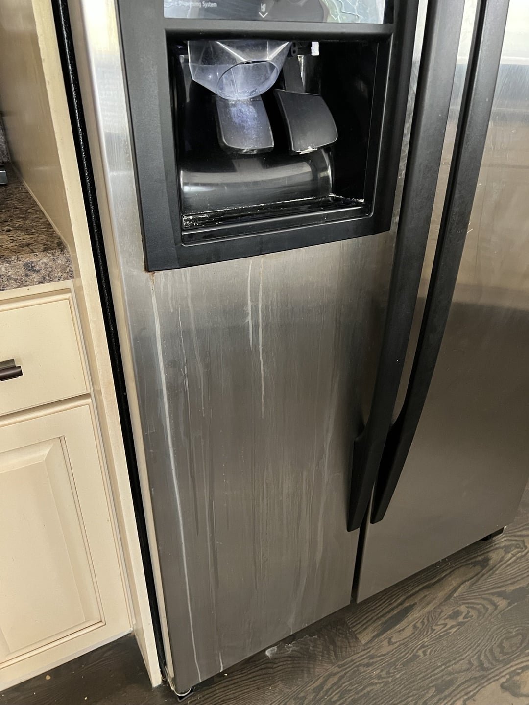 A microfiber cloth polishes a wet stainless steel knife until shiny.