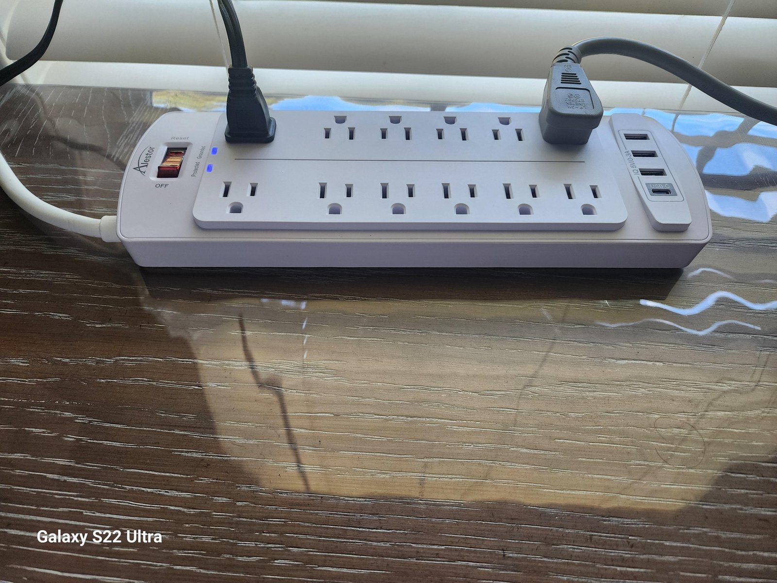 A microwave power cord plugged securely into a wall outlet for safe operation.