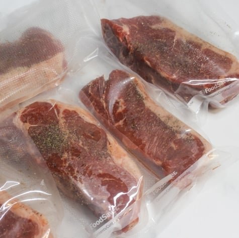 Sous vide cooking equipment arranged on a marble counter for common questions.