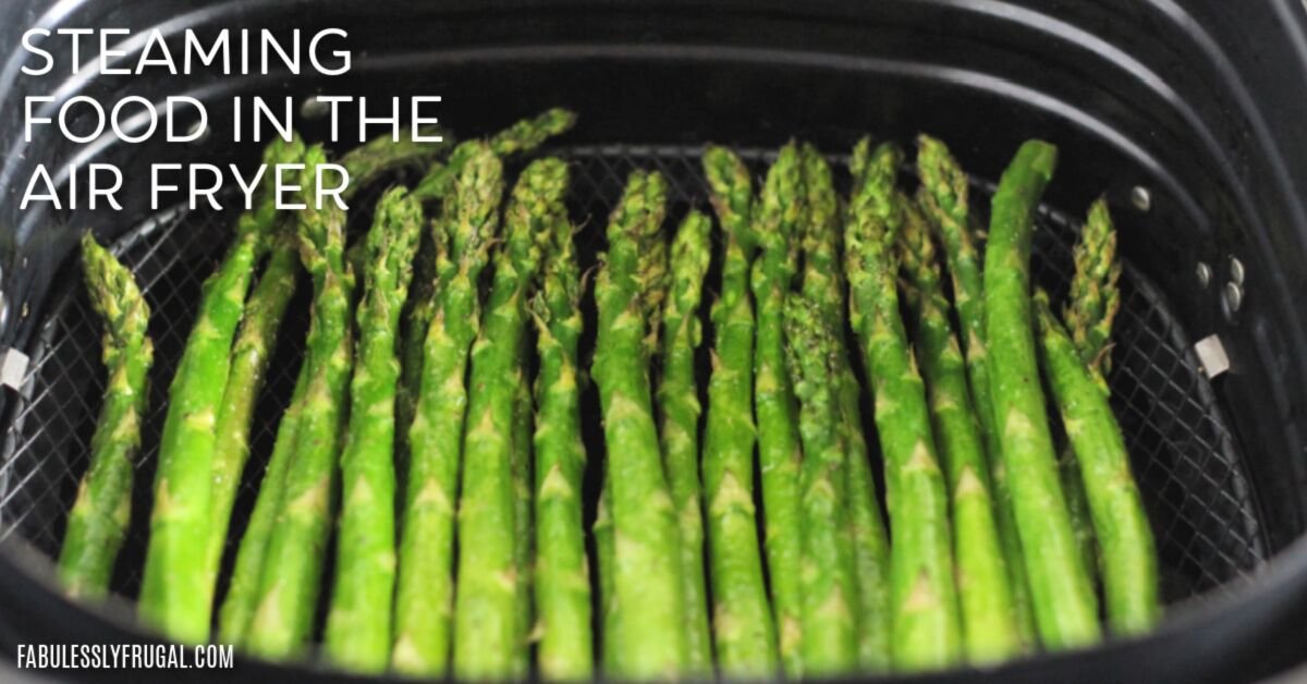 Steaming broccoli in a metal basket over boiling water on a stove.