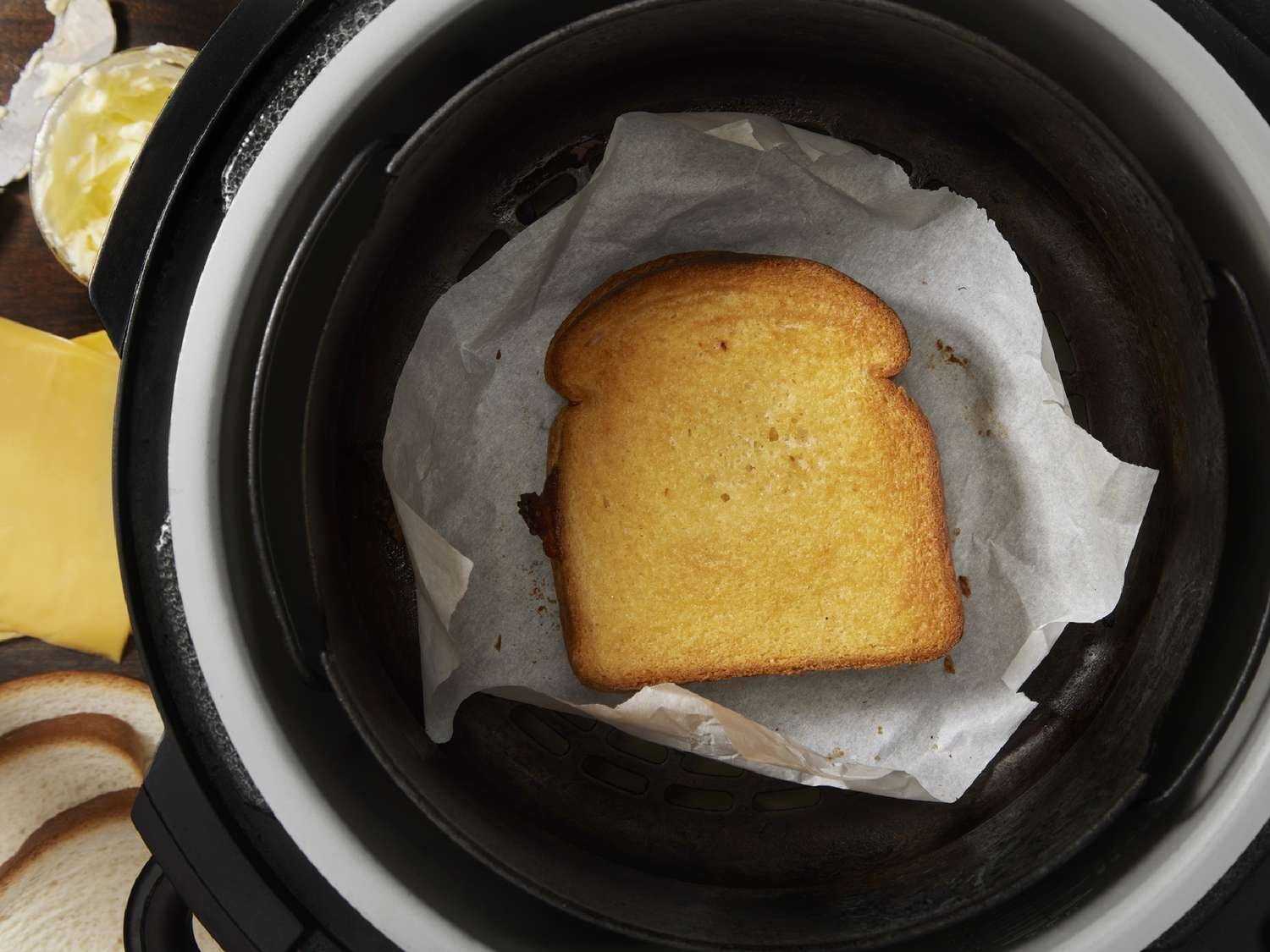 Parchment paper liners should be weighed down by food inside an air fryer basket.